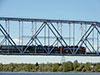 Электровозом ЭП20 с пассажирским поездом с вагоном-лабораторией контактной сети в составе на Кузьминском мосту через Неву